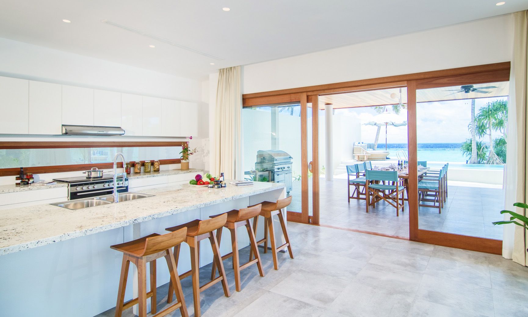 The fabulously equipped kitchen with a large island in in our private beachfront Family Residences and Villas.