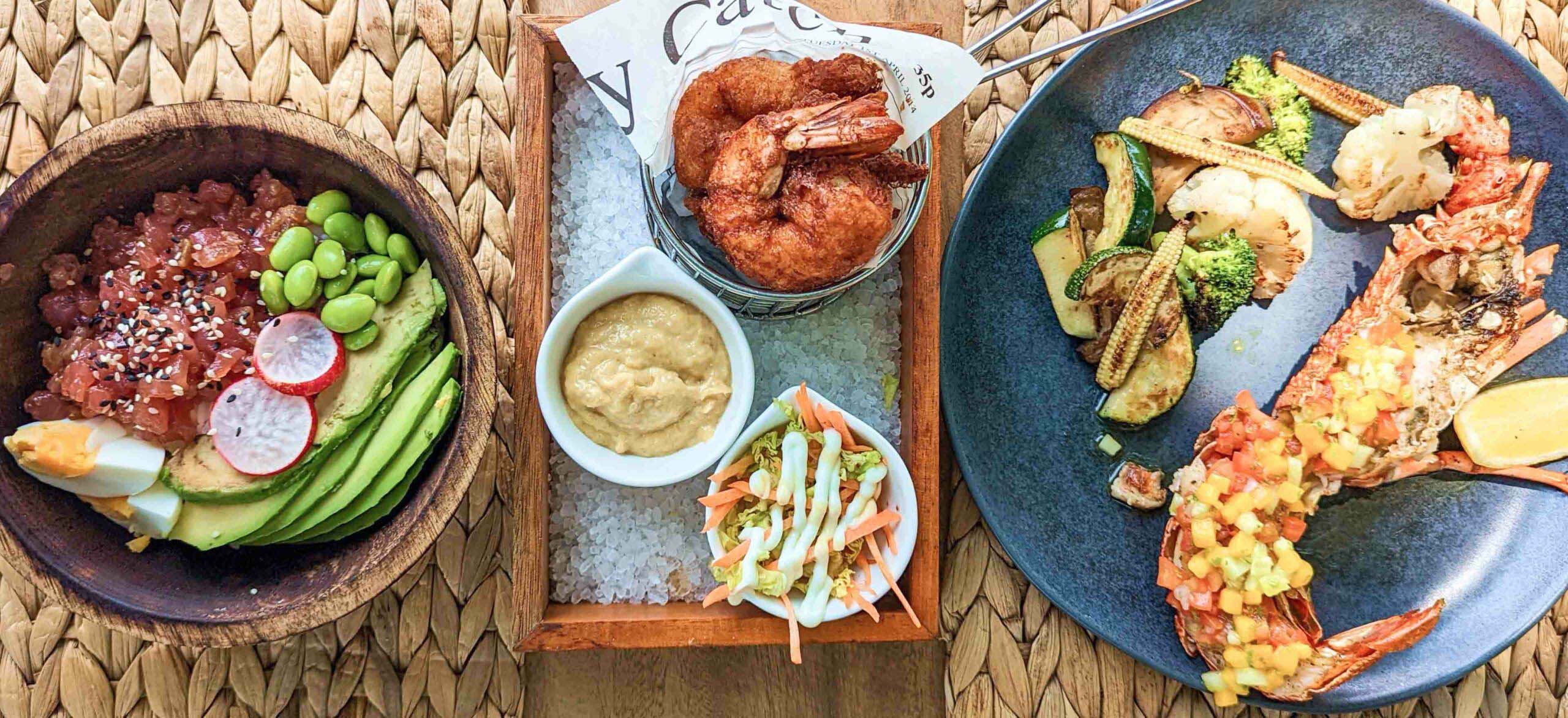 Traditional Maldivian cuisine at the Emperor Beach Club, with the Poke Bowl and Half-tail Reef Lobster.