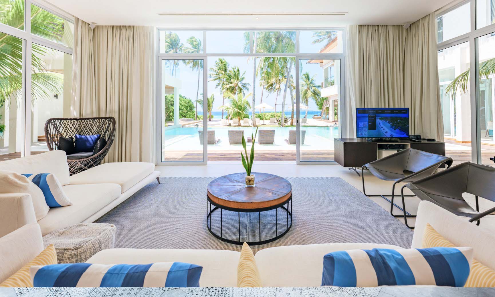 The large living area with floor to ceiling windows inside of our luxury Maldives Family Accommodations.