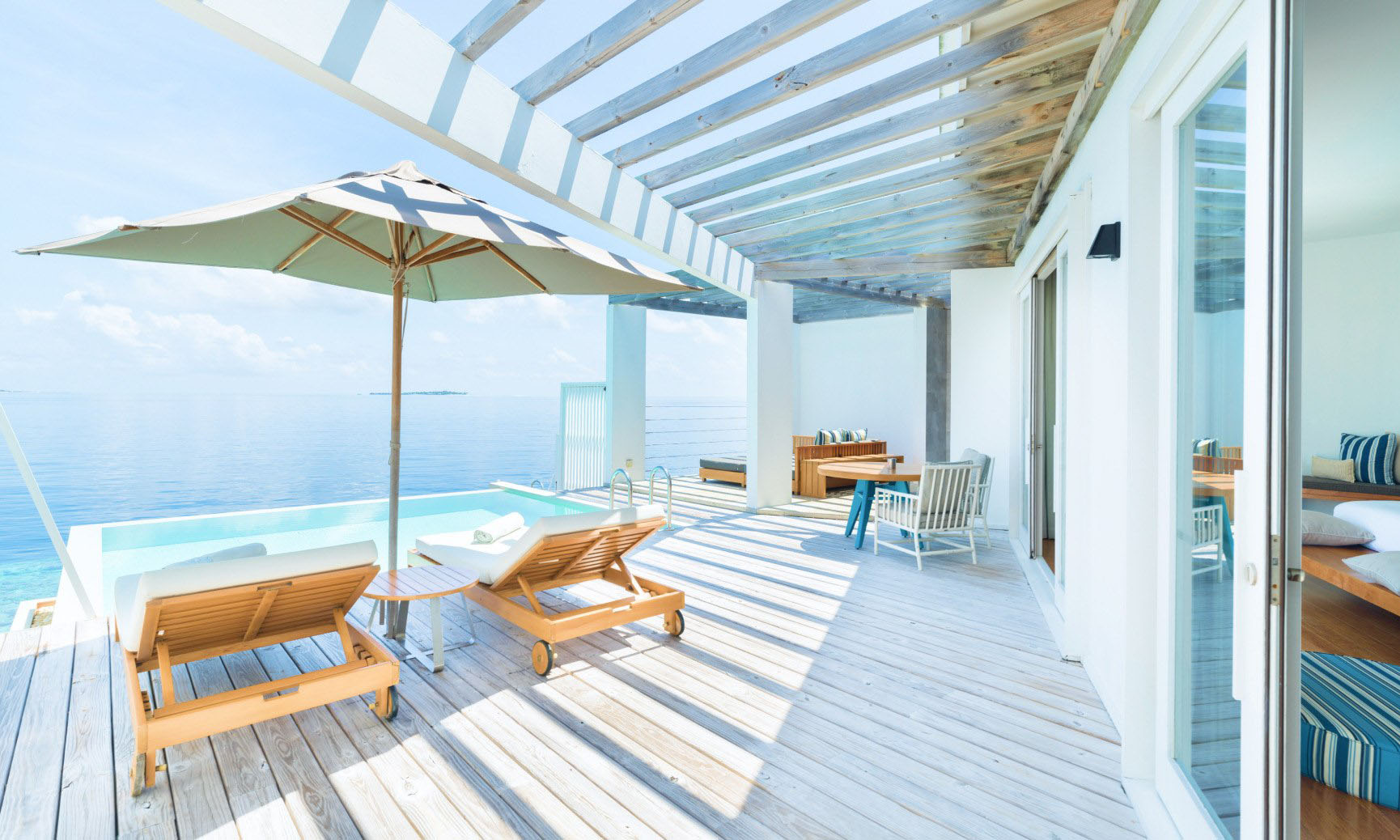 The al fresco dining area and private freshwater pool located on the sundeck of our Maldives Reef Water Villa.