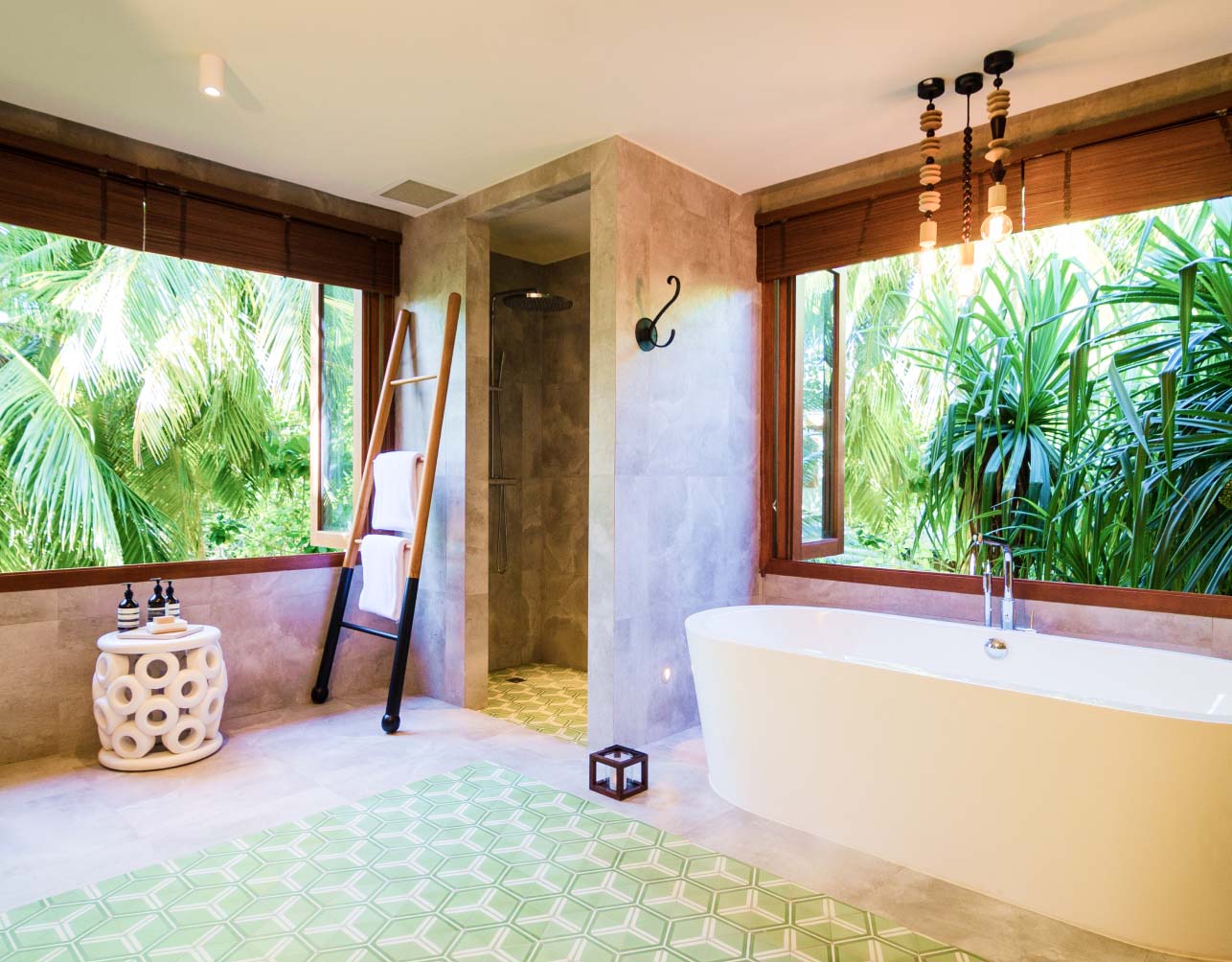 The spacious soaking tub for 2 and rain shower inside our Maldives Treetop Villas.