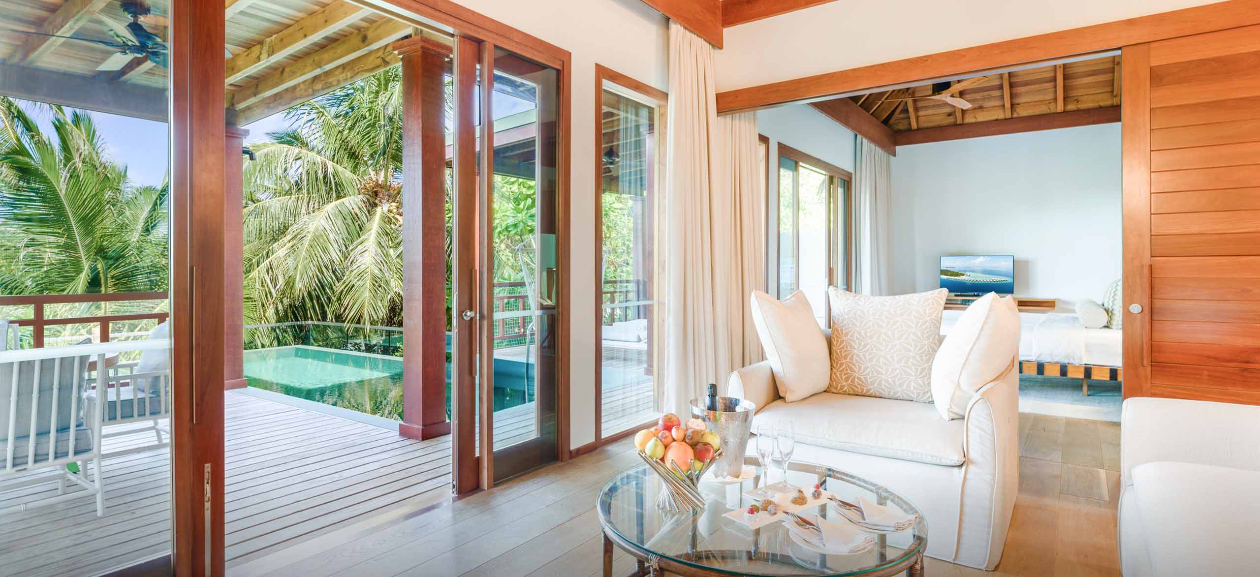 The view of the sundeck and private freshwater pool from the living room inside of our Maldives Treetop Villas.