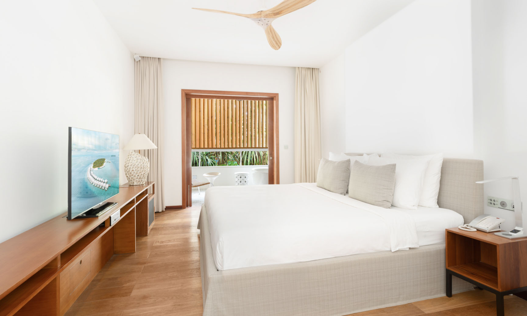 A guest suite with a king bed and private balcony in our 4 bedroom villa in the Maldives.