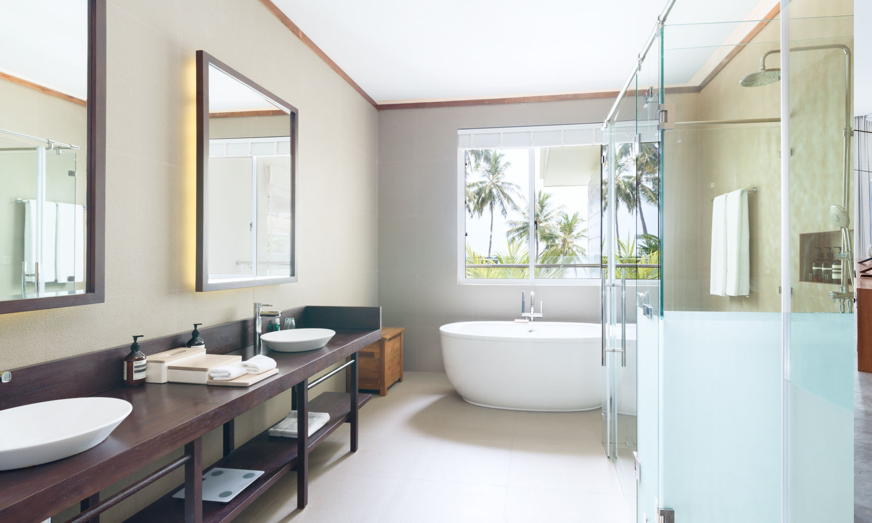 An ensuite bathroom with double sinks, a soaking tub for two and rain shower inside of our Mansion in the Maldives.