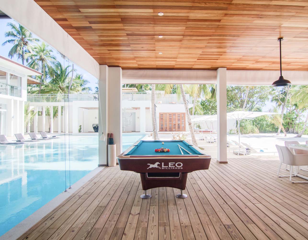 A fully equipped games terrace with a pool table and ample outdoor seating at our Luxury Maldives Family Accommodations.