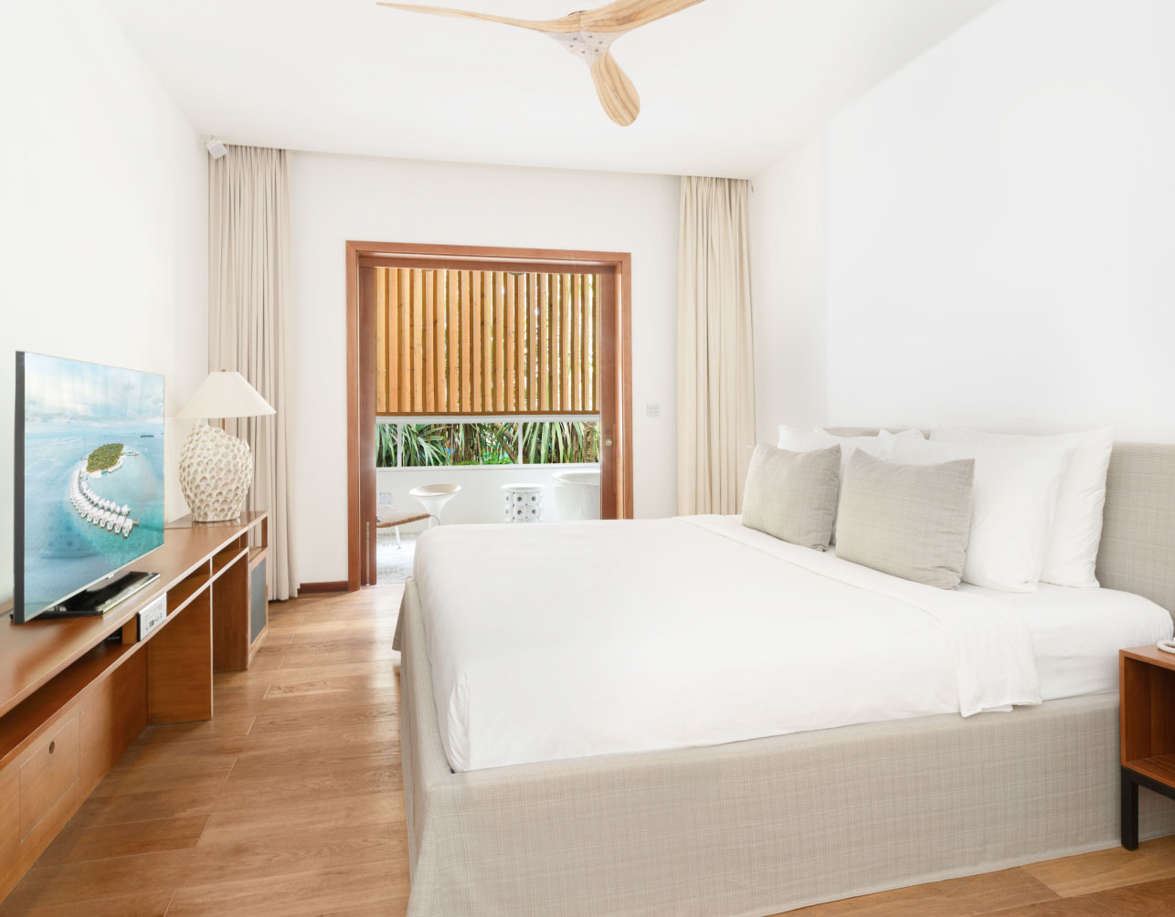 A guest suite with a king bed and private balcony in our our Private Residence in the Maldives.