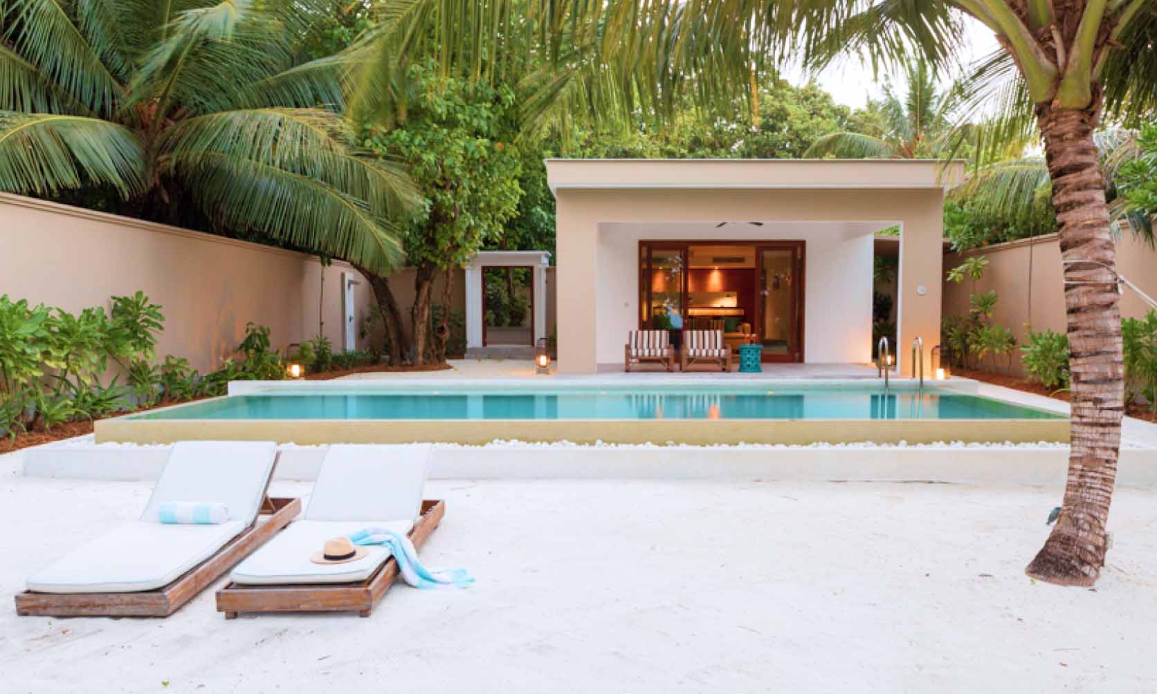 An outside view of our one bedroom villa's pool and sundeck from the beach.